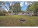 Large backyard with an installed firepit, offering lots of green space and an outdoor retreat at 119 Mayfair Cir, Sanford, FL 32771