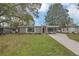 Inviting home with manicured lawn, complemented by trees and an extended driveway at 119 Mayfair Cir, Sanford, FL 32771