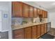 Bright kitchen showcasing wood cabinets, granite countertops, tile backsplash, and stainless steel appliances at 119 Mayfair Cir, Sanford, FL 32771