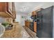 Well-lit kitchen features granite countertops, tile backsplash, stainless steel appliances and wood cabinets at 119 Mayfair Cir, Sanford, FL 32771