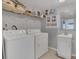 Well-organized laundry space features a washer, dryer, storage shelves, and a convenient sink at 119 Mayfair Cir, Sanford, FL 32771