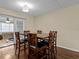 Dining room with a wooden table and chairs that seats six, with adjacent views of living spaces at 1228 Walker S Cir, Lakeland, FL 33805