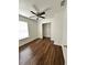 Bright bedroom with wood floors, ceiling fan, closet, and window providing natural light at 1352 Sw 69Th Rd, Bushnell, FL 33513