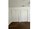 Bedroom features wood-look flooring and two reach-in closets with sliding doors at 1352 Sw 69Th Rd, Bushnell, FL 33513