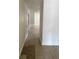 Hallway showcasing tile flooring, white walls, and doorways leading to other rooms at 1352 Sw 69Th Rd, Bushnell, FL 33513