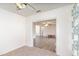 View from carpeted room to an open living room with wood-look flooring at 1417 High Point Blvd # 150D, Orlando, FL 32825