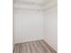Walk-in closet featuring wood-look vinyl floors and wire shelving at 1417 High Point Blvd # 150D, Orlando, FL 32825