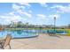 High Point Community Pool with tables, umbrellas, and view of the lake with a fountain at 1417 High Point Blvd # 150D, Orlando, FL 32825