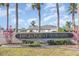 High Point of Orlando Community entrance with lush landscaping, palm trees, and blue skies at 1417 High Point Blvd # 150D, Orlando, FL 32825