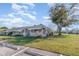 Relaxing single story home with a green lawn and a large tree adding to its curb appeal at 1417 High Point Blvd # 150D, Orlando, FL 32825