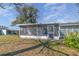 The back of the house features a screened porch and lush lawn at 1417 High Point Blvd # 150D, Orlando, FL 32825