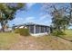 The back of the house features a screened porch and lush lawn at 1417 High Point Blvd # 150D, Orlando, FL 32825