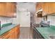 Well-lit kitchen area featuring plenty of cabinet space and an adjoining living area at 1417 High Point Blvd # 150D, Orlando, FL 32825