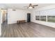 Open living room with wood-look flooring, natural light, and a glimpse of the hallway at 1417 High Point Blvd # 150D, Orlando, FL 32825