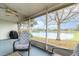 Relax on the screened porch overlooking the lake, complete with comfortable seating and a ceiling fan at 1417 High Point Blvd # 150D, Orlando, FL 32825