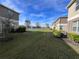 A well-manicured lawn shared by adjacent properties with a water feature in the distance at 15198 Harrington Cove Dr, Orlando, FL 32824