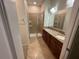 Bathroom featuring a tile shower and dual sinks with granite countertops at 15198 Harrington Cove Dr, Orlando, FL 32824
