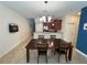 Open dining room with a large table and chairs, leading to a modern kitchen at 15198 Harrington Cove Dr, Orlando, FL 32824