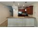 Kitchen featuring stainless steel appliances, dark wood cabinets, and a breakfast bar at 15198 Harrington Cove Dr, Orlando, FL 32824