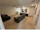 Spacious living room with comfortable sofas, ceiling fan, and neutral carpeting at 15198 Harrington Cove Dr, Orlando, FL 32824