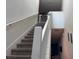 Carpeted staircase with white railings leading to the upper level at 15198 Harrington Cove Dr, Orlando, FL 32824