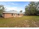 The backyard has a patio space, brick siding and a lush lawn at 1600 Amboy Dr, Deltona, FL 32738