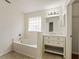 This bathroom offers a soaking tub, ample lighting, and a modern vanity at 1600 Amboy Dr, Deltona, FL 32738