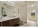 Bathroom featuring a dark wood vanity with ample storage space and a bright window view at 1600 Amboy Dr, Deltona, FL 32738