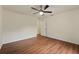 Bedroom with wood-look floors, ceiling fan, and neutral walls, providing a bright living space at 1600 Amboy Dr, Deltona, FL 32738