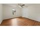 Bedroom featuring wood-look floors, ceiling fan with light, and a window that offers exterior views at 1600 Amboy Dr, Deltona, FL 32738