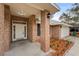 Inviting front porch of a brick home with manicured landscaping and outdoor lighting at 1600 Amboy Dr, Deltona, FL 32738