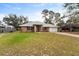 Charming single-story brick home featuring a well-maintained lawn and attached garage at 1600 Amboy Dr, Deltona, FL 32738