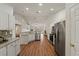 Bright kitchen with stainless steel appliances, and a seamless flow into the living area at 1600 Amboy Dr, Deltona, FL 32738