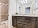 Bathroom features dual sinks, granite countertops, and sleek cabinetry at 1602 Lima Ave, Kissimmee, FL 34747