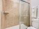 Bathroom featuring glass shower and beige tiles at 1602 Lima Ave, Kissimmee, FL 34747