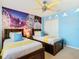 Fun ' bedroom with twin beds, mural, and ceiling fan at 1602 Lima Ave, Kissimmee, FL 34747