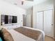 Bedroom featuring a stylish bed, closet, and a TV with neutral decor and ample space at 1602 Lima Ave, Kissimmee, FL 34747