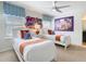 Bedroom featuring two beds, cartoon wall art, and patterned window treatments, adding charm and character at 1602 Lima Ave, Kissimmee, FL 34747