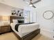 Comfortable bedroom featuring a stylish bed, nightstand, and wall art with decorative lamps and a fan at 1602 Lima Ave, Kissimmee, FL 34747