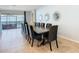 Open-concept dining room area featuring a long dining table with seating for 12 and view to the backyard pool at 1602 Lima Ave, Kissimmee, FL 34747
