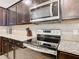 Updated kitchen featuring stainless steel appliances and granite countertops for a modern and functional design at 1602 Lima Ave, Kissimmee, FL 34747