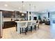 Open concept kitchen with breakfast bar, stainless steel appliances and direct view into the living area at 1602 Lima Ave, Kissimmee, FL 34747