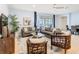 Comfortable living room area featuring neutral paint and decor, and sliding glass door access to the screened pool at 1602 Lima Ave, Kissimmee, FL 34747