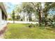 Expansive backyard featuring mature trees, lush greenery, and a privacy fence at 1621 Crescent Rd, Longwood, FL 32750
