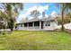 Spacious backyard with lush green lawn and screened-in patio, perfect for outdoor entertaining at 1621 Crescent Rd, Longwood, FL 32750