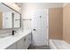 Bright bathroom features a marble countertop, black hardware, framed mirror, and a shower over the bathtub at 1621 Crescent Rd, Longwood, FL 32750