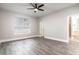 Bedroom boasts wood-look tile floors, a ceiling fan, and an ensuite bathroom, providing a comfortable retreat at 1621 Crescent Rd, Longwood, FL 32750