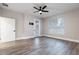 Bright bedroom with wood-look tile floors, a ceiling fan, and a door to the outside, and a large window at 1621 Crescent Rd, Longwood, FL 32750