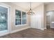 Vaulted dining room with a modern chandelier, view of the screened porch, and wood flooring at 1621 Crescent Rd, Longwood, FL 32750