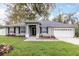 Charming single-story home with well-manicured lawn and a two-car garage at 1621 Crescent Rd, Longwood, FL 32750